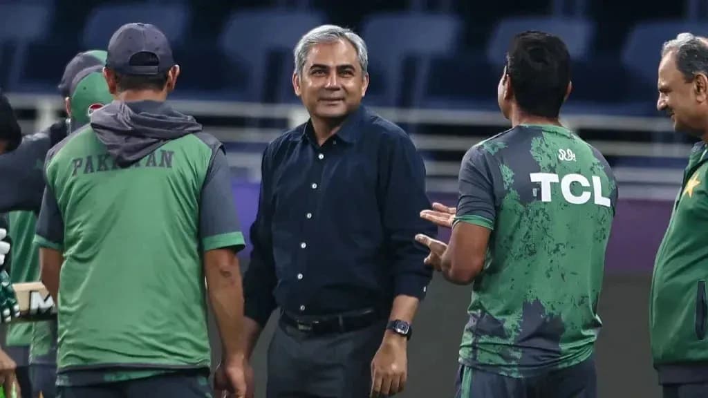Coaching staff discussing strategies during practice session