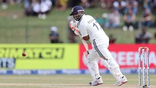 Batsman playing a defensive shot in cricket match
