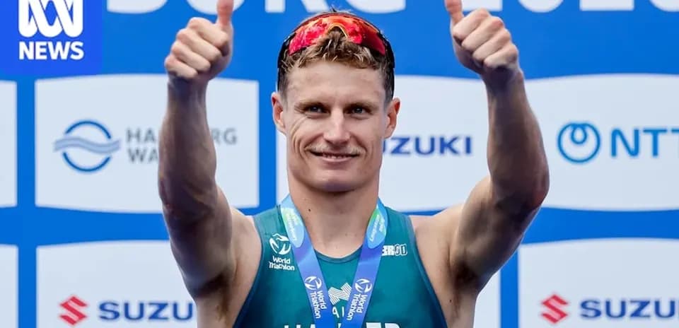 Athlete celebrating with thumbs up after race