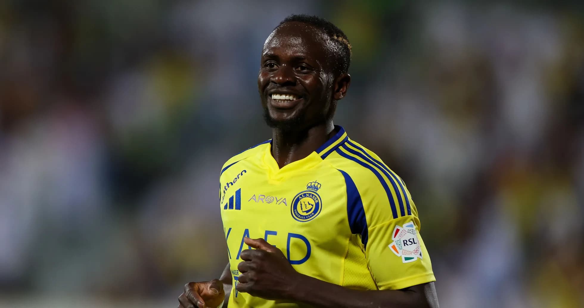 Player smiling in yellow and blue team jersey