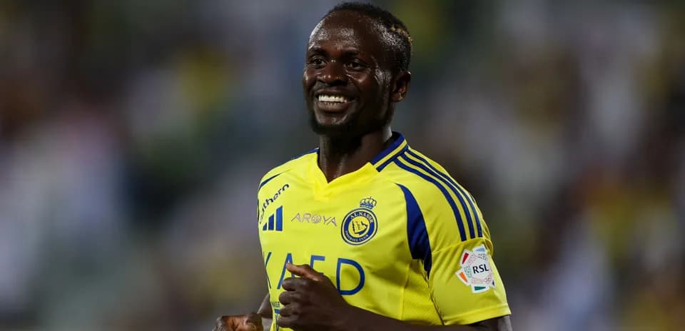 Player smiling in yellow and blue team jersey