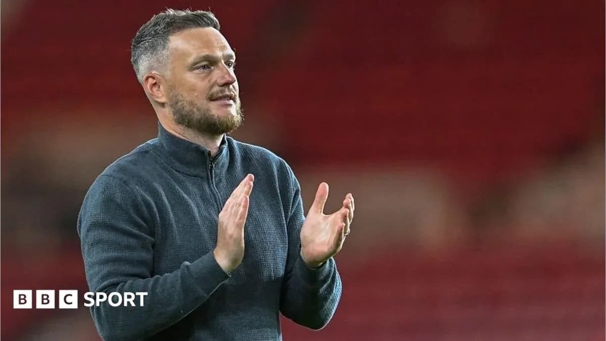 Coach applauding during match at stadium