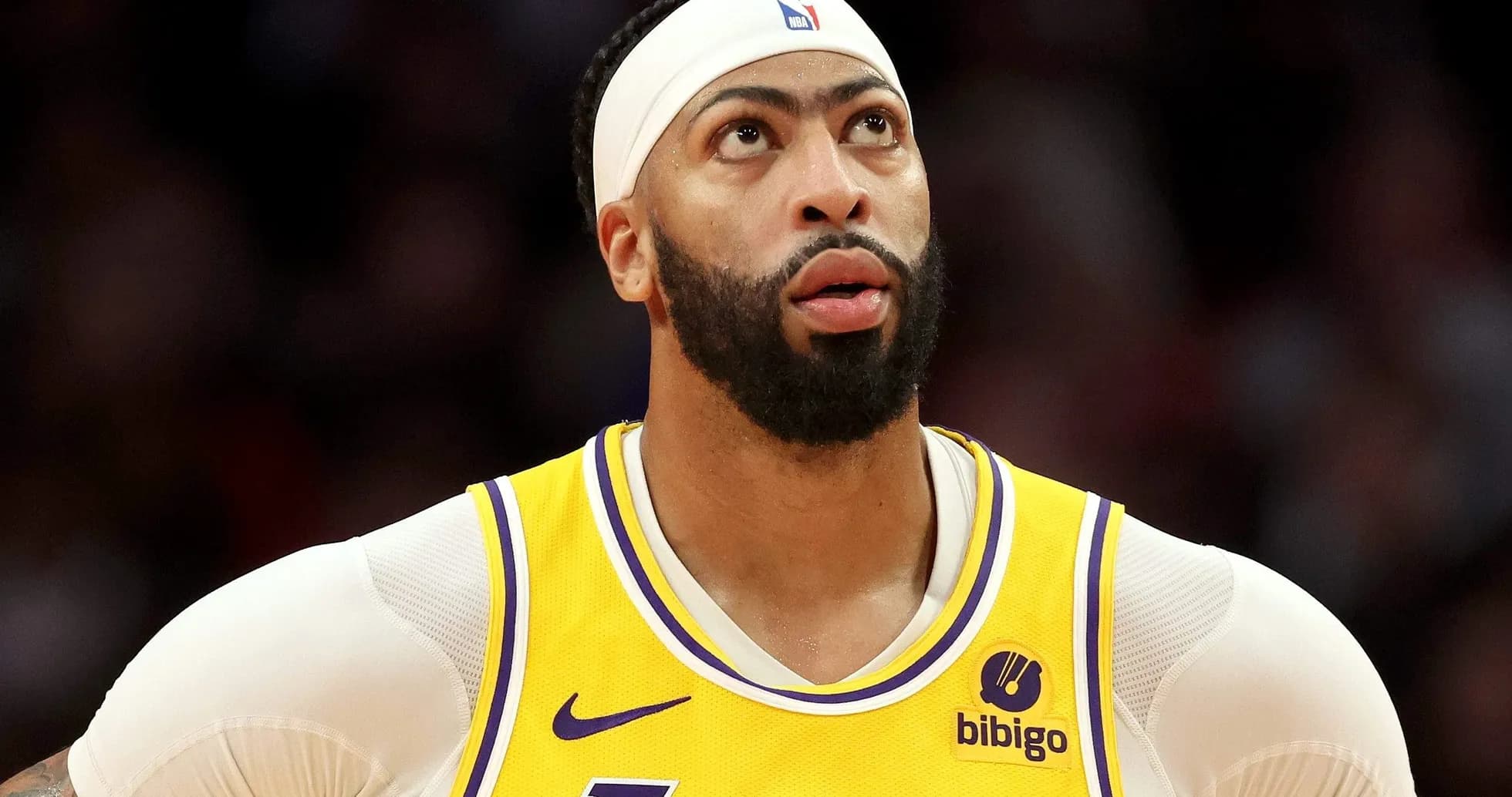 Player in Lakers jersey looking up during game