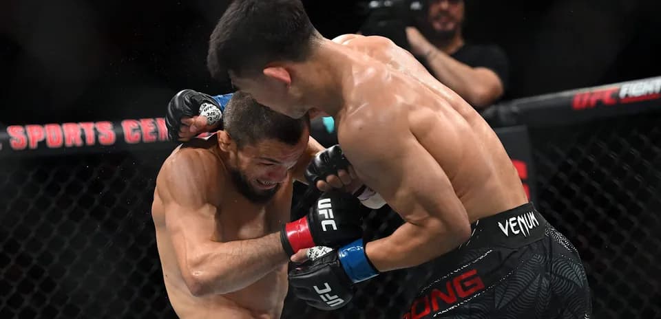 Two fighters exchanging punches in UFC match