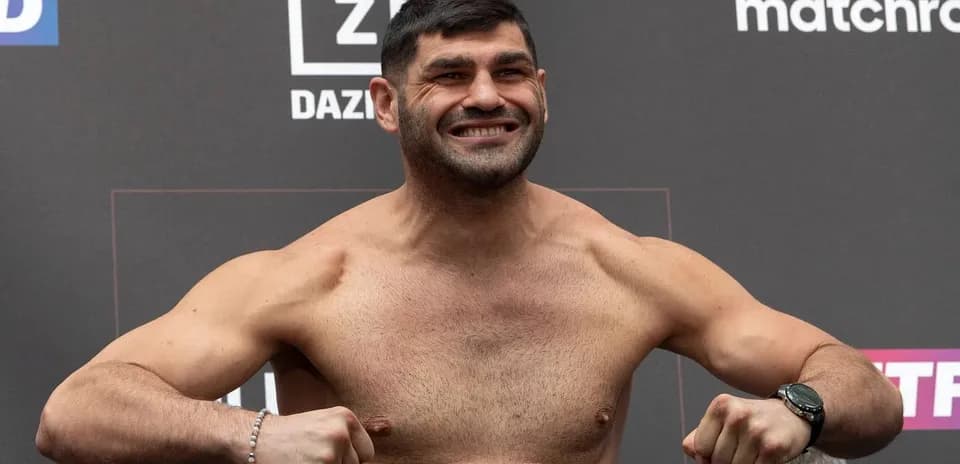 Fighter posing at weigh-in event with smile