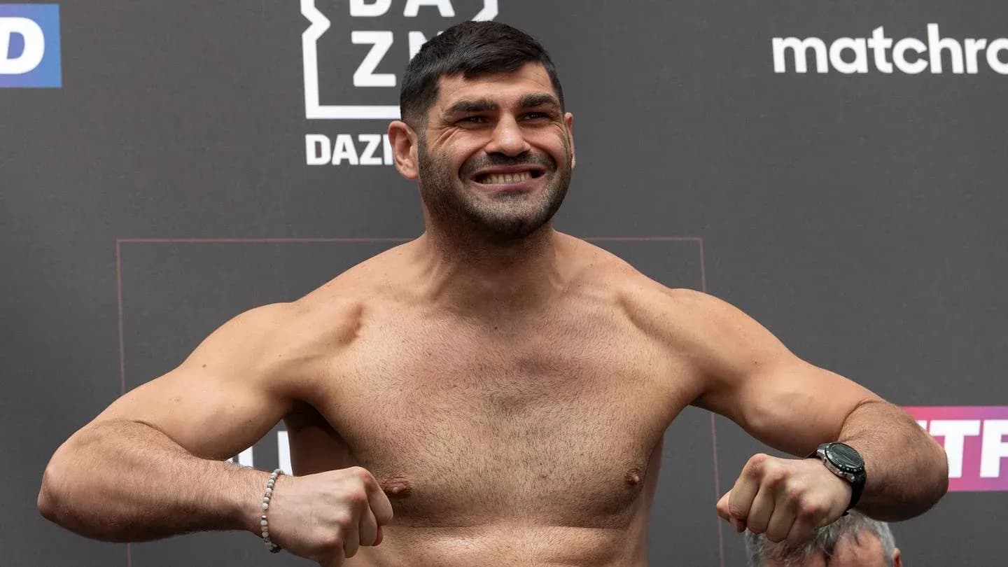 Fighter posing at weigh-in event with smile