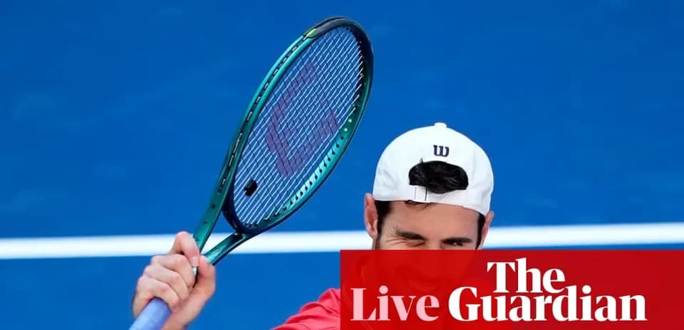 Tennis player preparing to serve on blue court