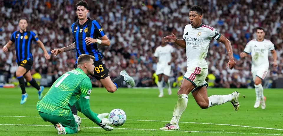 Real Madrid player running past goalkeeper in match