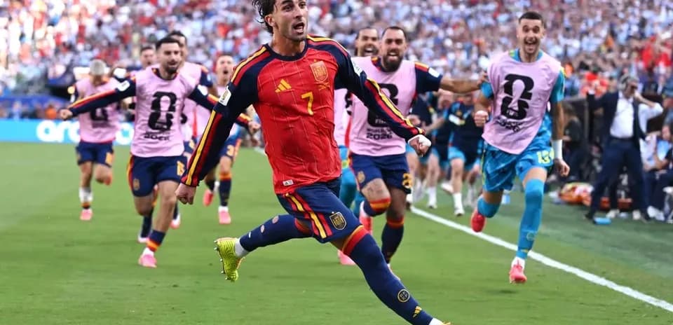 Spanish player celebrating goal with teammates in background