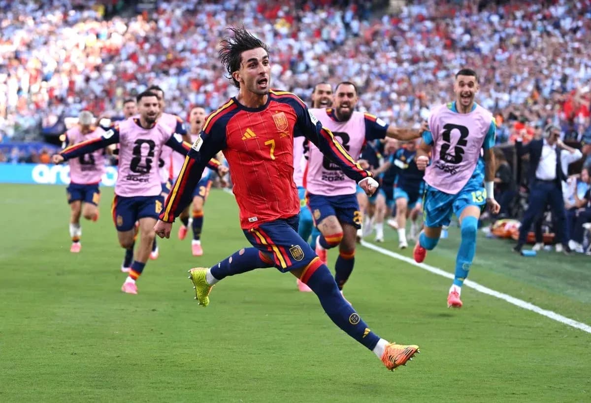 Spanish player celebrating goal with teammates in background