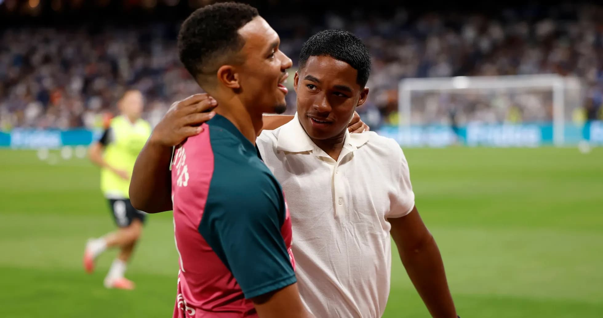 Two young men interacting on a football pitch