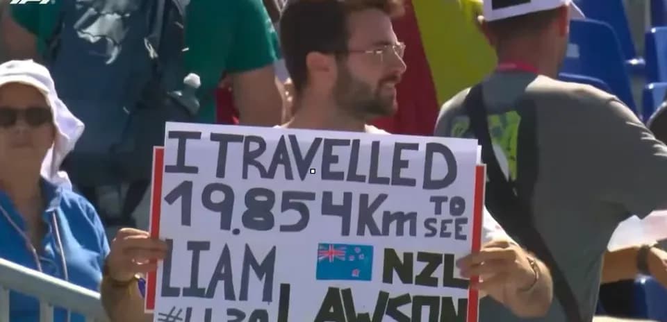 Fan holding sign supporting Liam Lawson at event