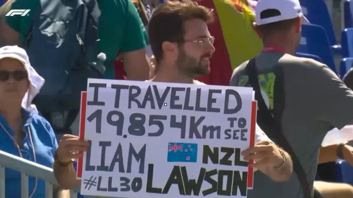 Fan holding sign supporting Liam Lawson at event