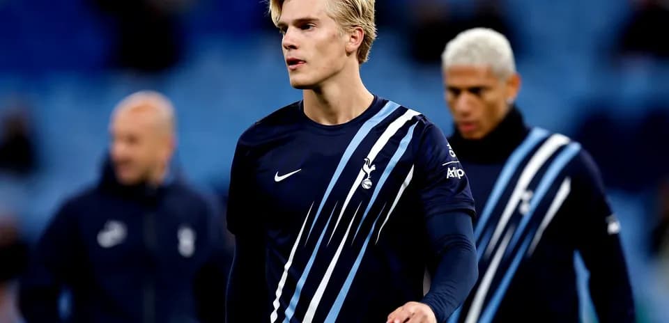 Player in Tottenham kit walking during warm-up