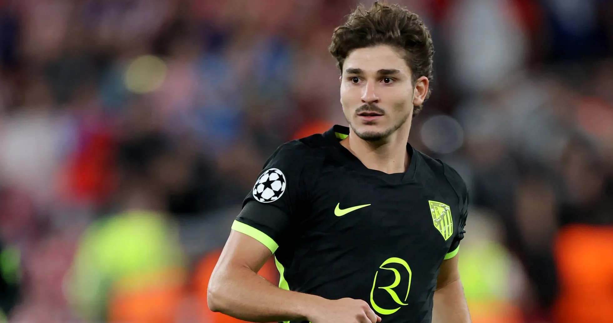 Player in black jersey during UEFA Champions League match