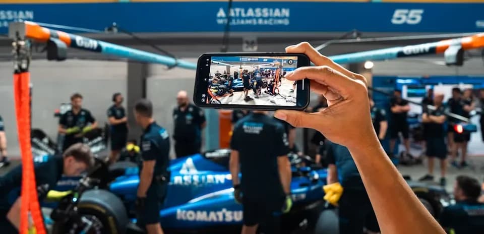 Team members working on a car in the garage