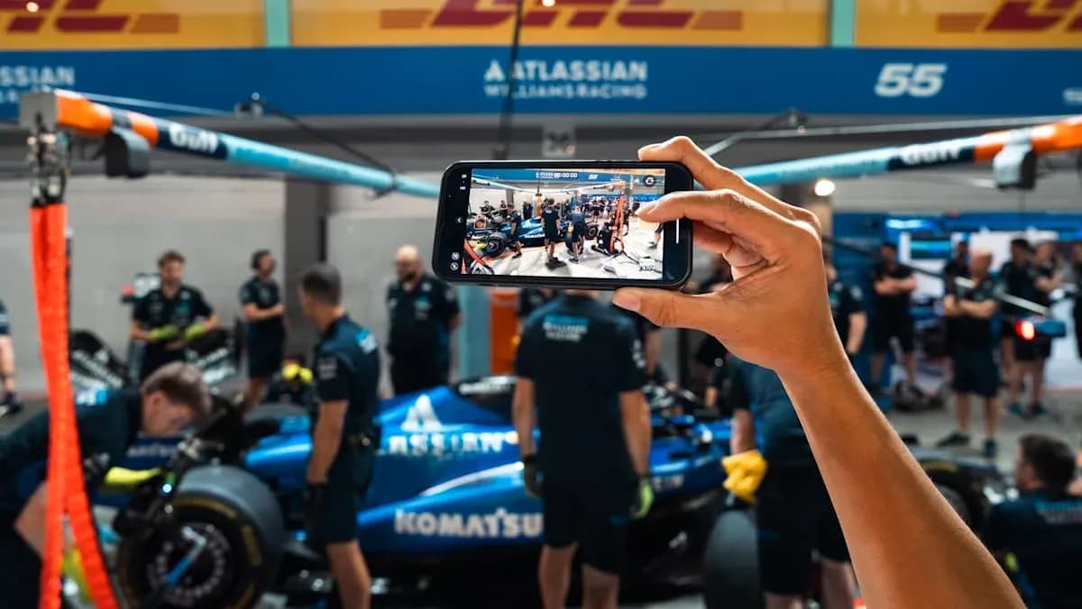 Team members working on a car in the garage