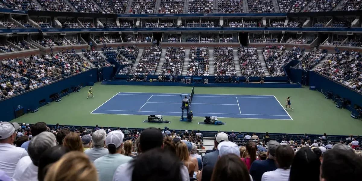 Tennis match in a crowded stadium with players