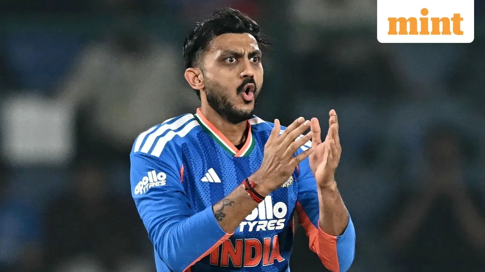 Cricketer celebrating during a match in blue jersey