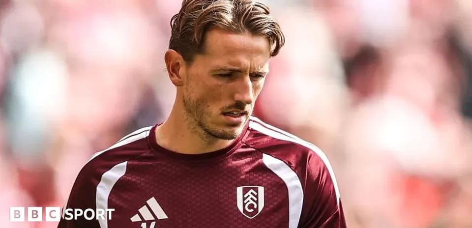 Player in maroon training kit before the match