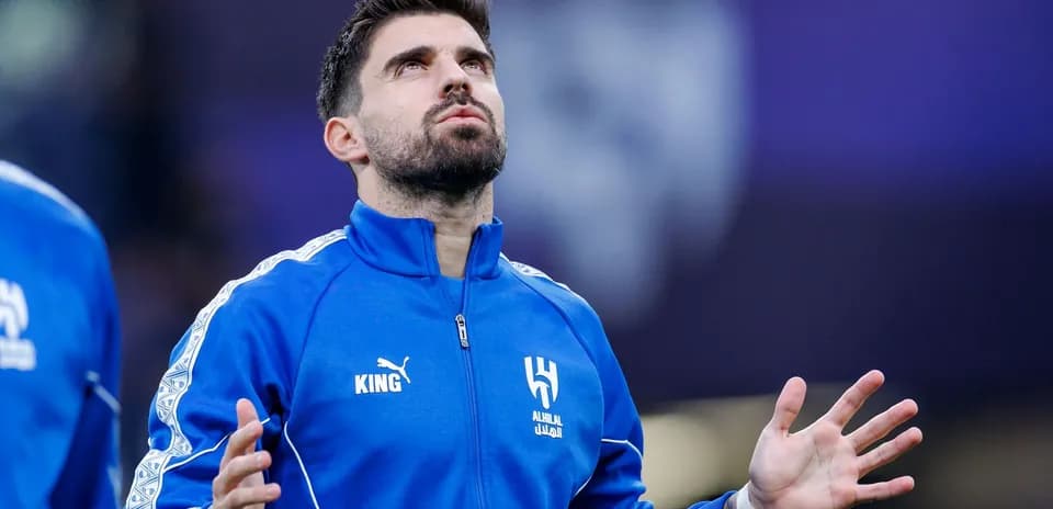 Player in blue jersey looking upwards during warm-up
