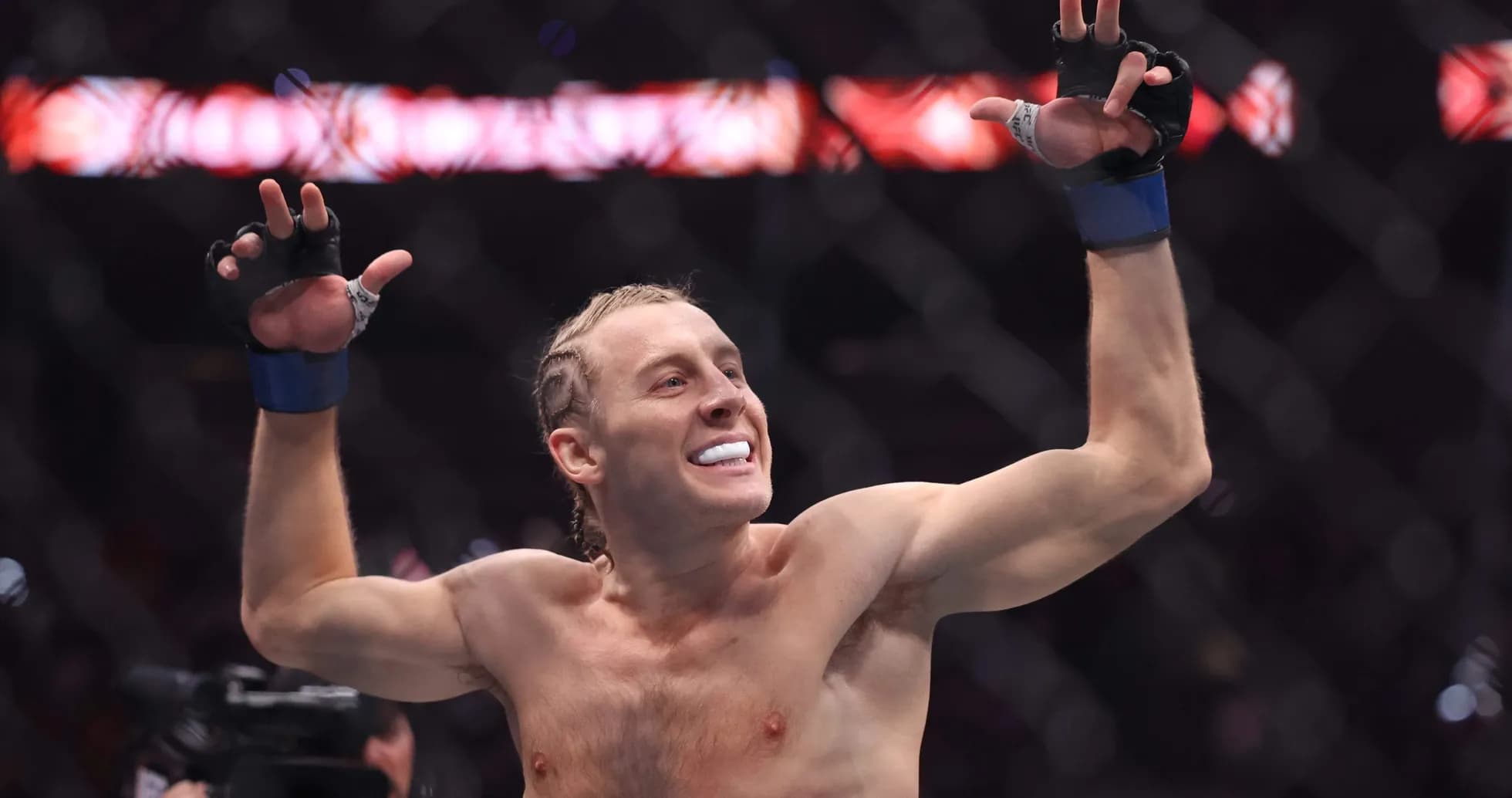 Fighter celebrating victory inside the octagon