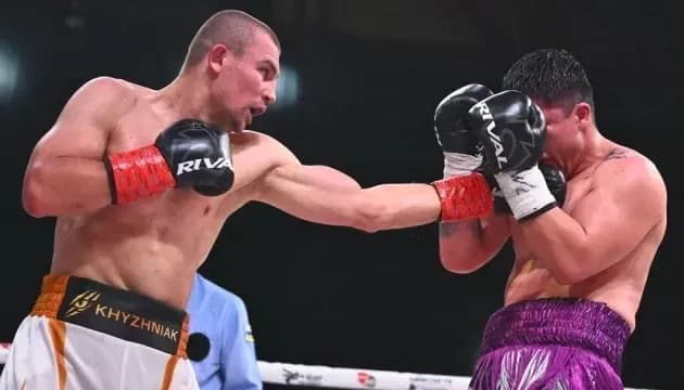 Boxer delivering a punch to opponent's face