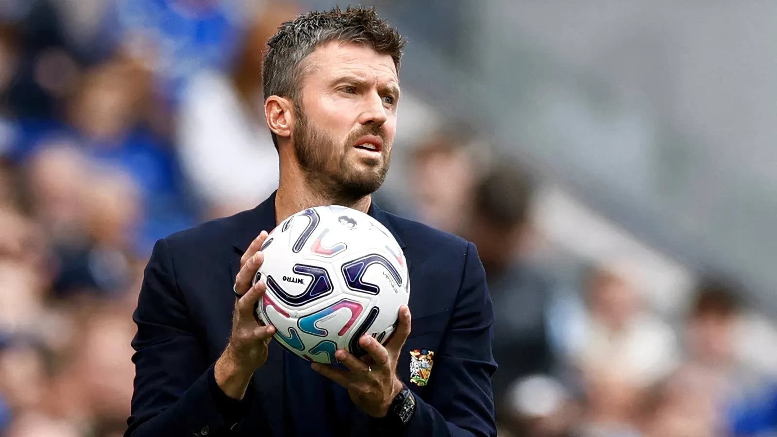 Coach holding ball during match preparation