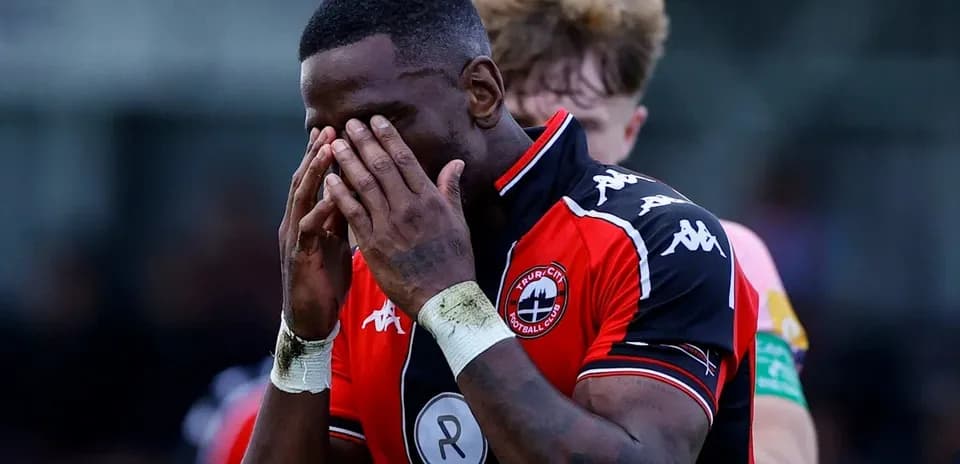 Player holding his face in disappointment on the field