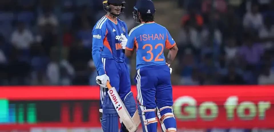 Two cricket players discussing strategy on field