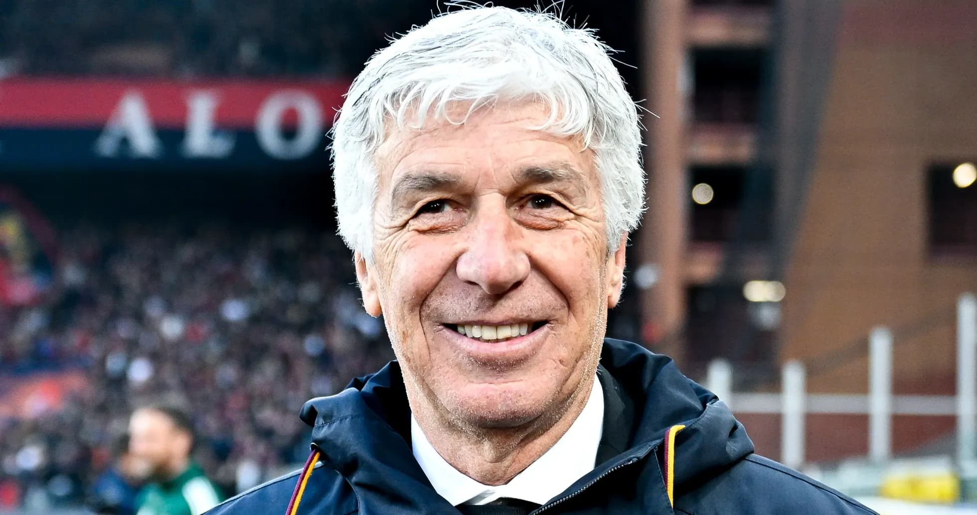 Coach smiling on the sidelines during match