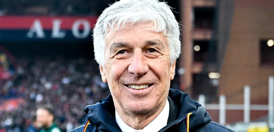Coach smiling on the sidelines during match