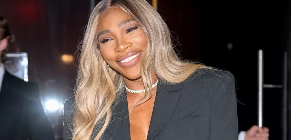 Woman smiling in a black blazer at event