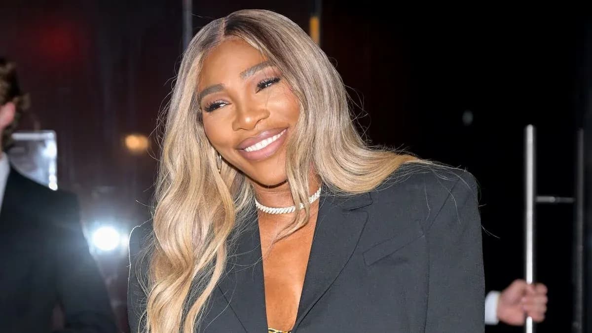 Woman smiling in a black blazer at event