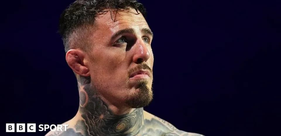 Athlete with tattoos looking up during match