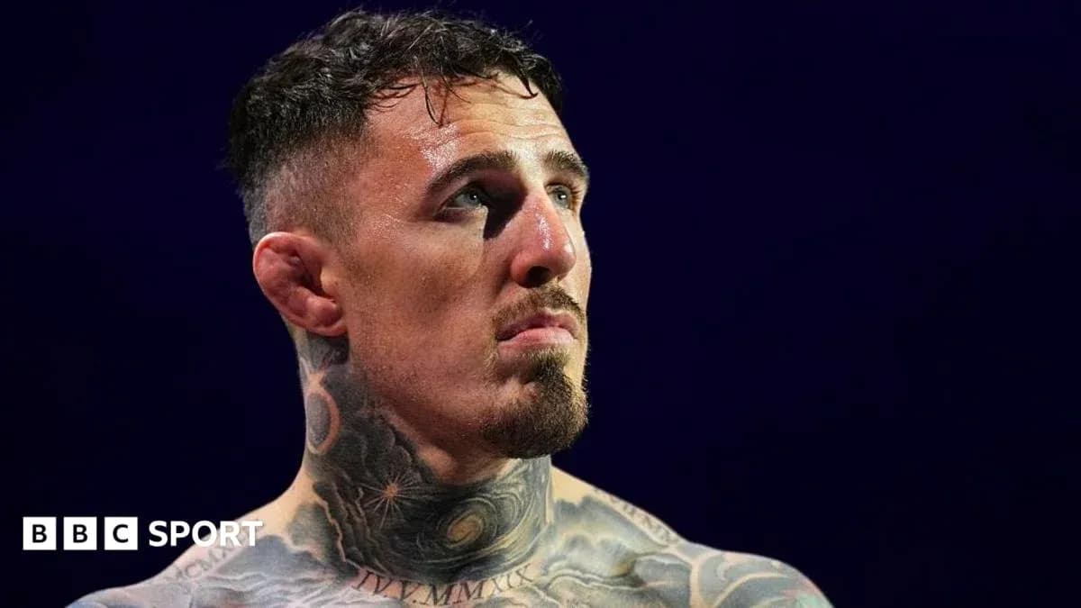 Athlete with tattoos looking up during match