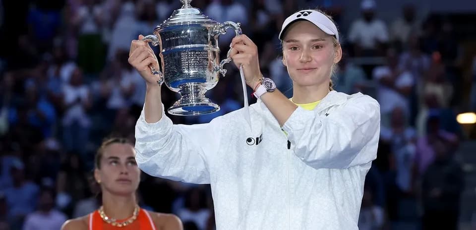 Player holding trophy with opponent in background