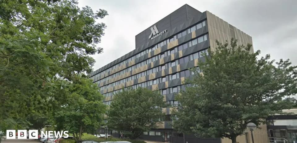 Marriott hotel building surrounded by trees and cars