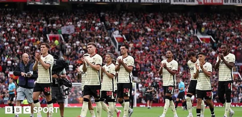 Players applauding fans after the match at Old Trafford