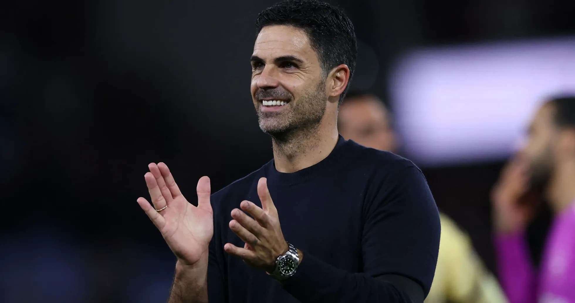 Coach applauding during a match on the sidelines