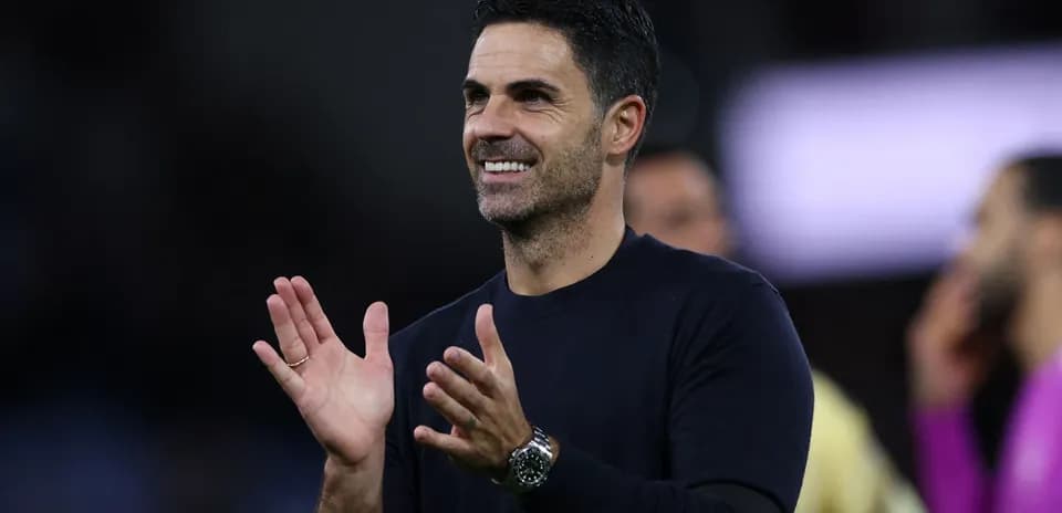 Coach applauding during a match on the sidelines