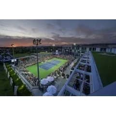 Crowd watching tennis match at sunset