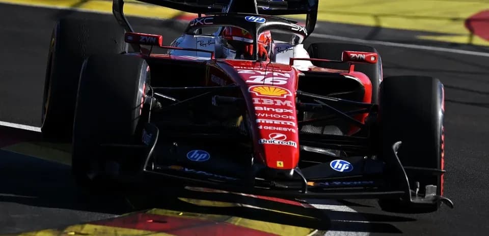 Ferrari F1 car navigating a racetrack corner