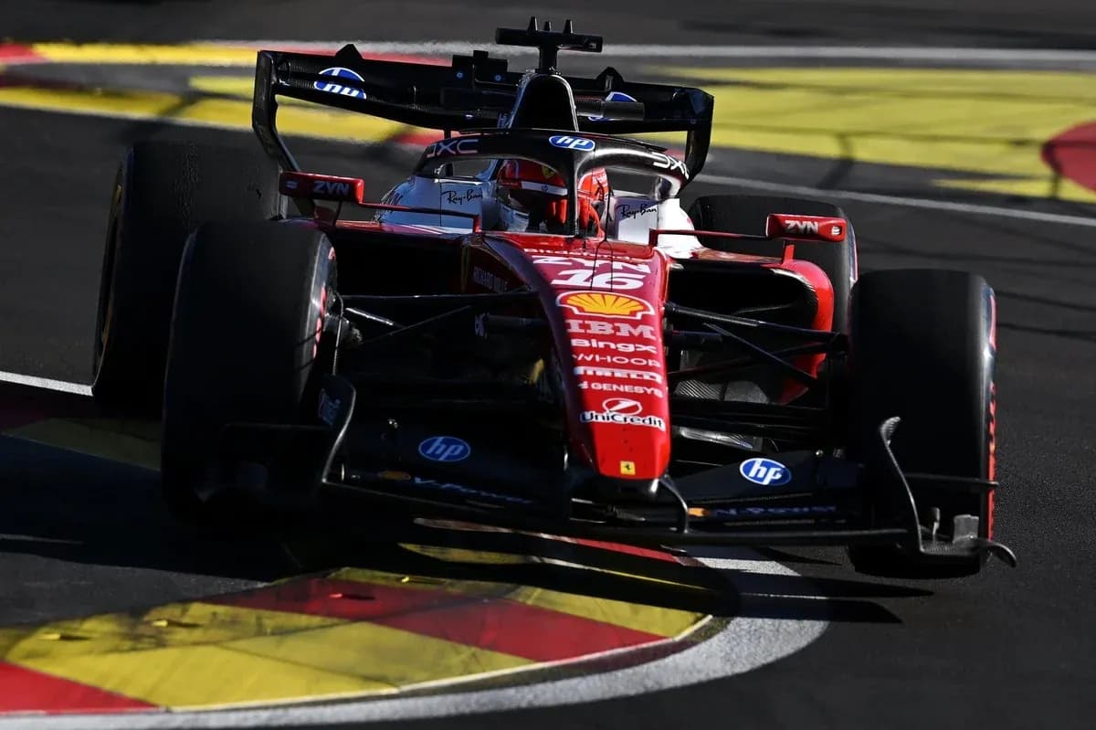 Ferrari F1 car navigating a racetrack corner