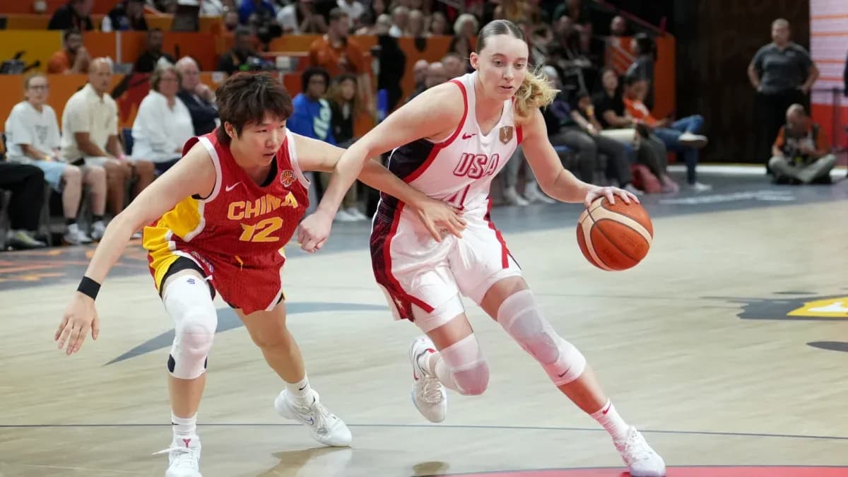 USA player dribbling past China defender in basketball game
