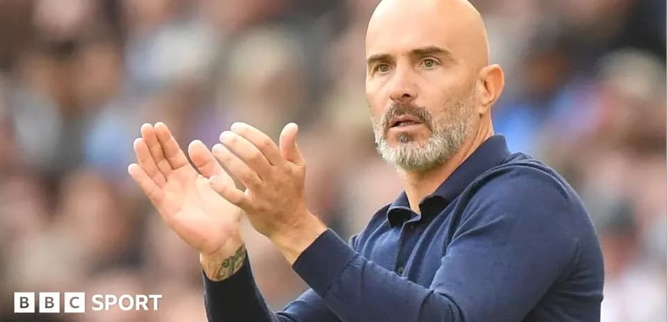 Coach clapping during a match from the sidelines