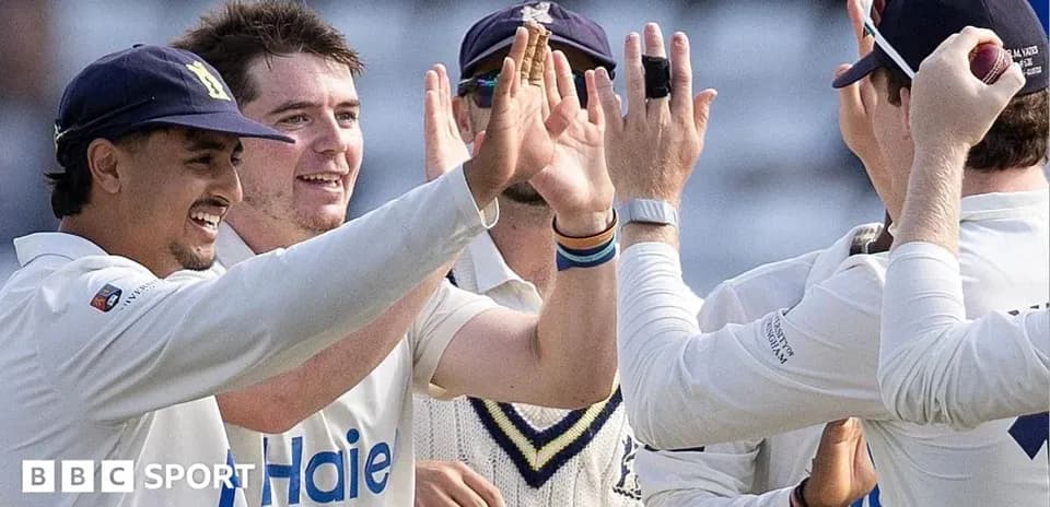 Cricket team celebrating a wicket on the field