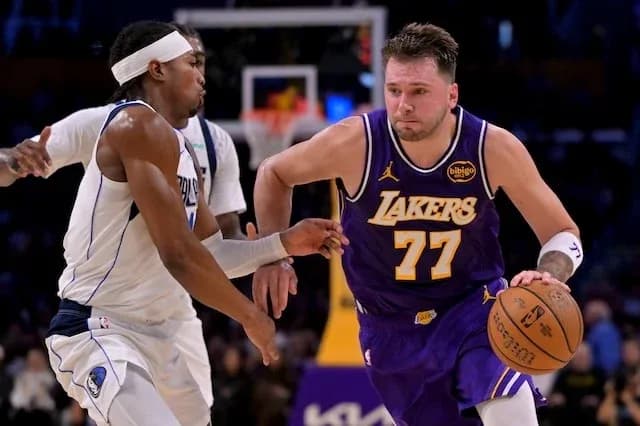 Player dribbling basketball while being guarded
