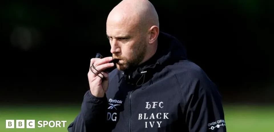 Coach blowing whistle during training session