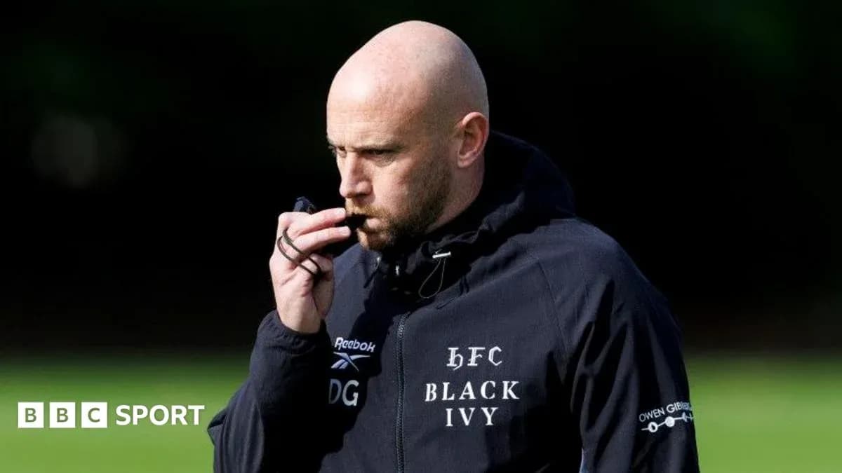 Coach blowing whistle during training session